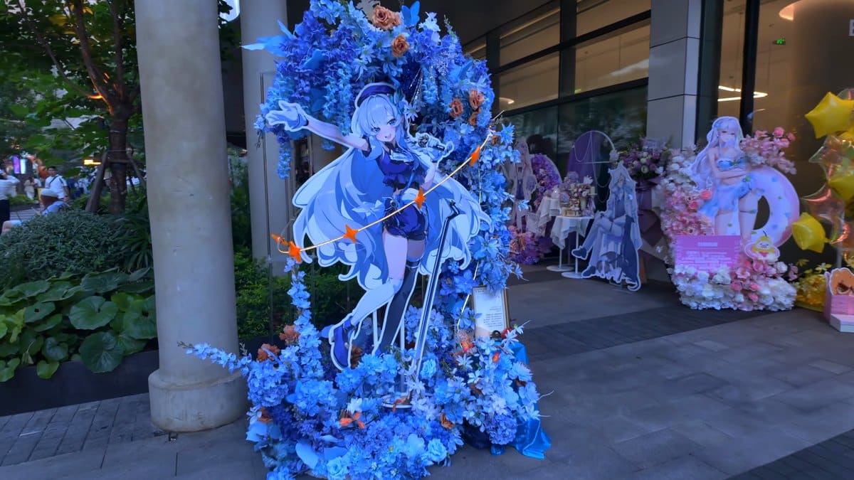 A blue-themed display of flowers and cut-out figures