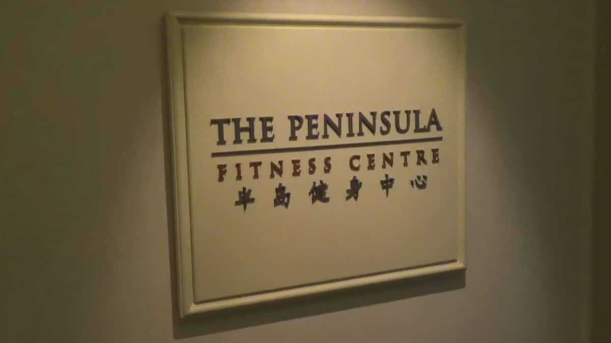 A brass-lettered plaque reading THE PENINSULA FITNESS CENTRE