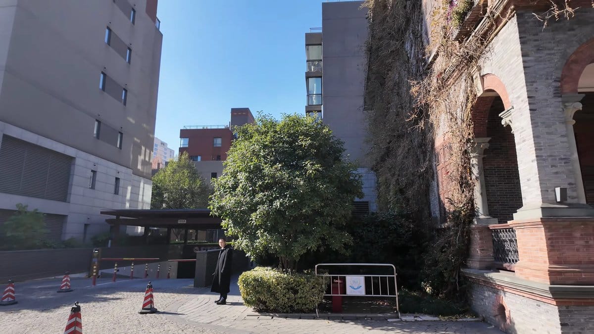 A brick building with a creeper-covered arcade, safety