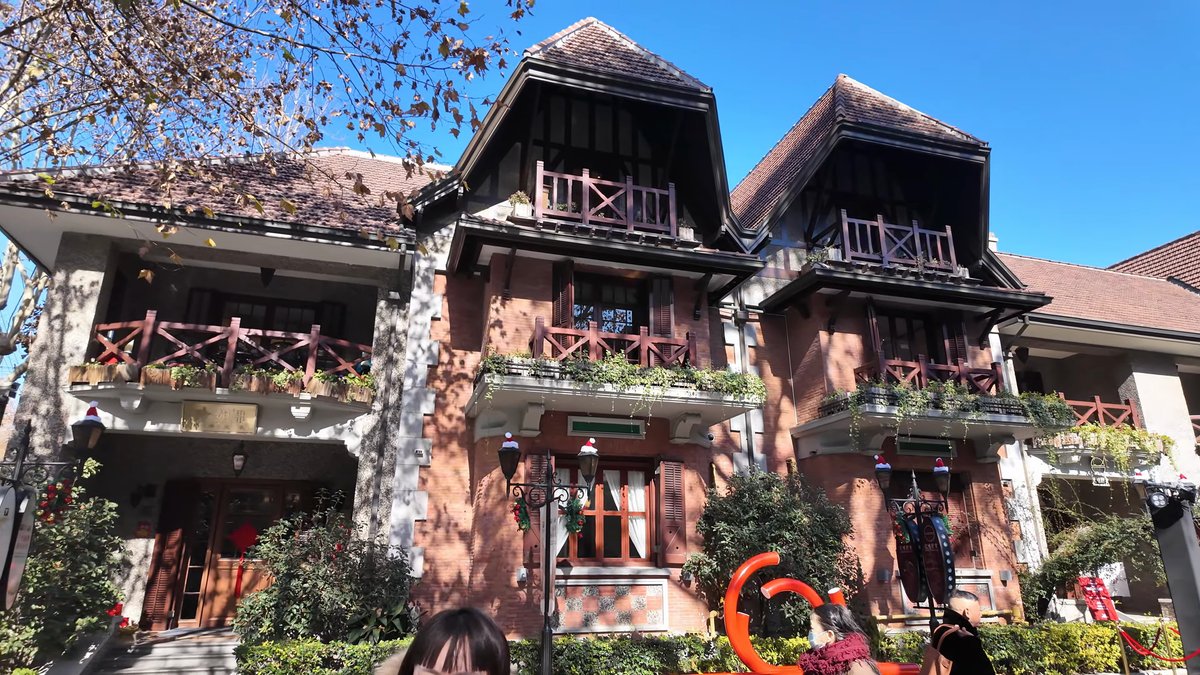 A brick villa with decorated balconies, one of