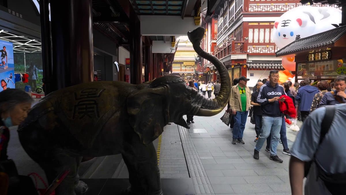 A bronze elephant sculpture standing in a covered