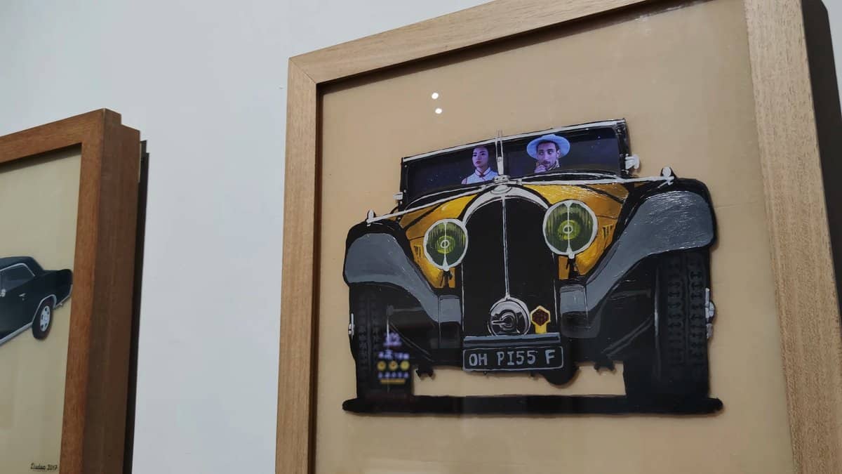 A framed relief of a vintage car with