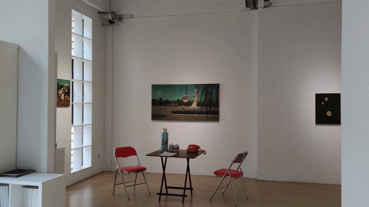 A gallery corner, a painting on the wall