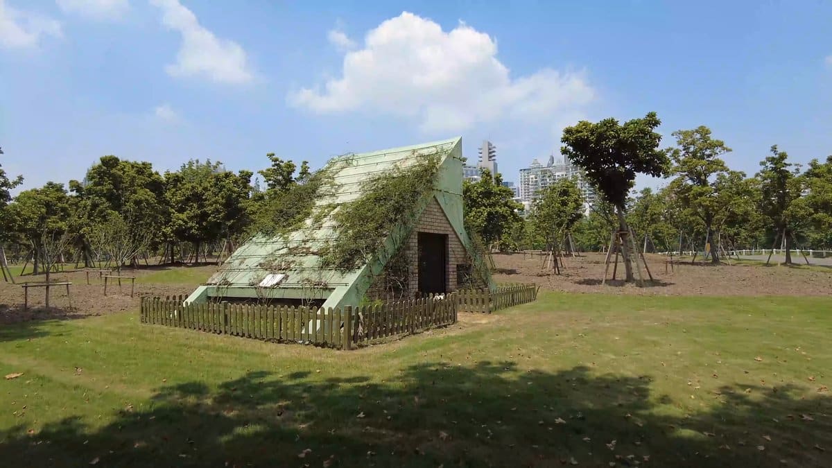 A grassed area with a green glazed pyramidal