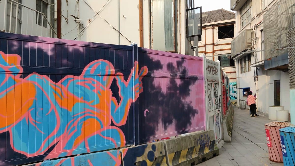 A hoarding painted with a swirling blue and