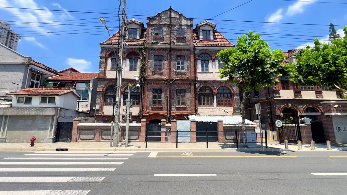 A large historic brick building set behind a