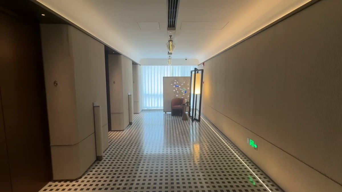 A long ground-floor corridor, light from a window