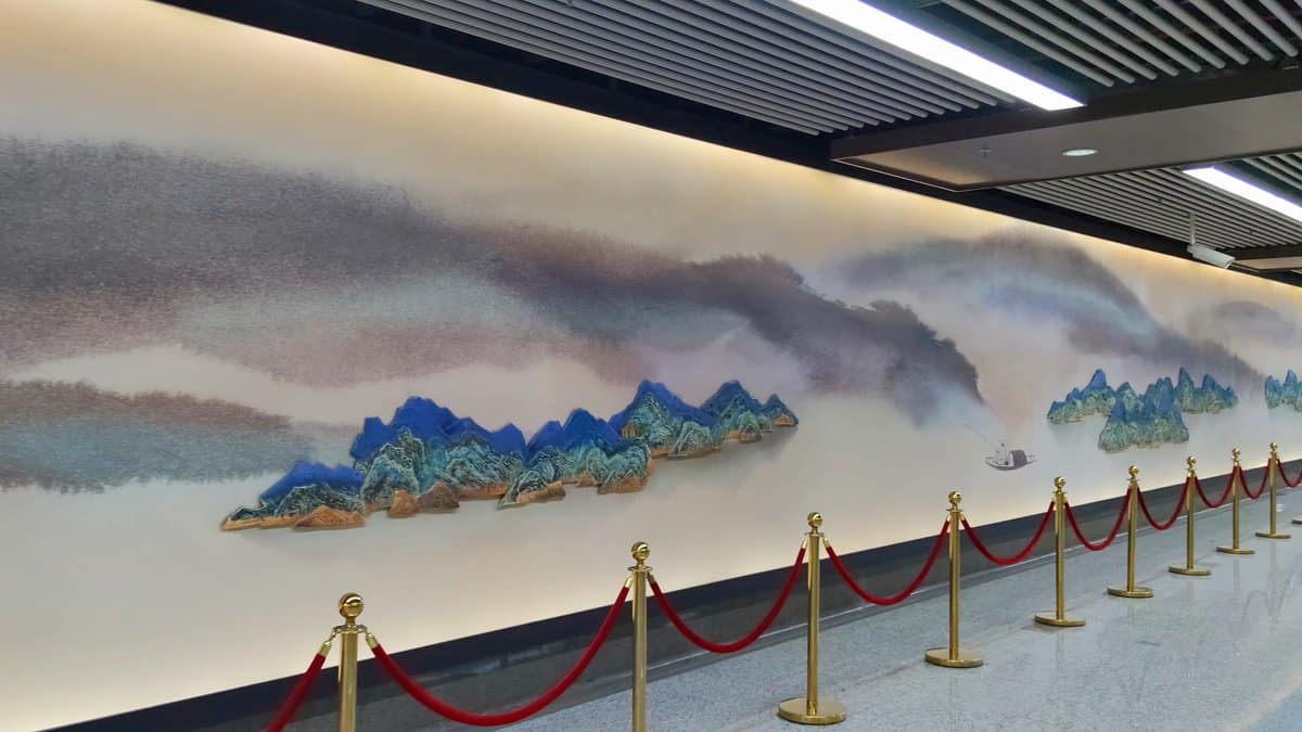 A long ink-painted landscape mural running down a
