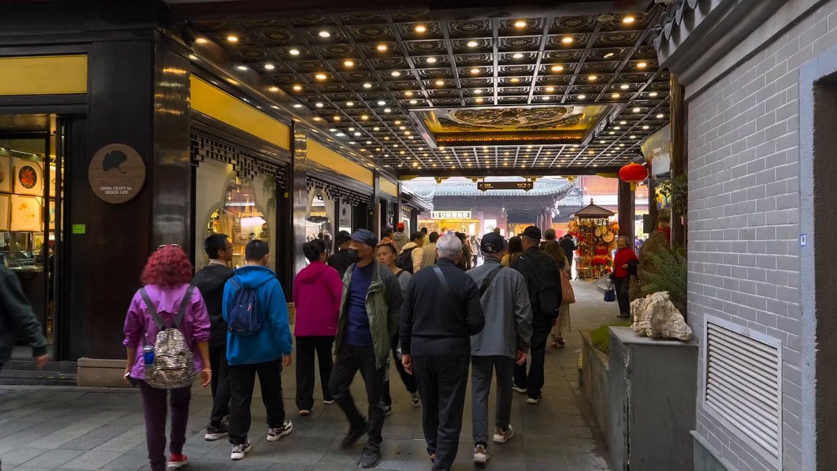 A modern arcade with a yellow slatted ceiling,