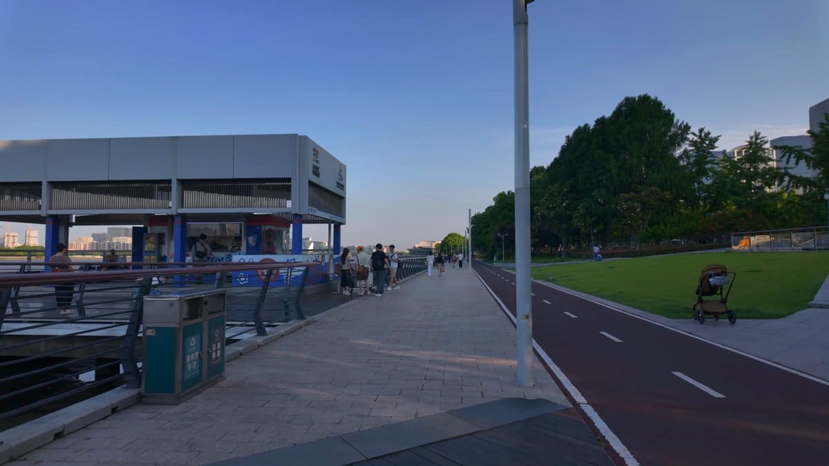 A modern pavilion beside the running track, people