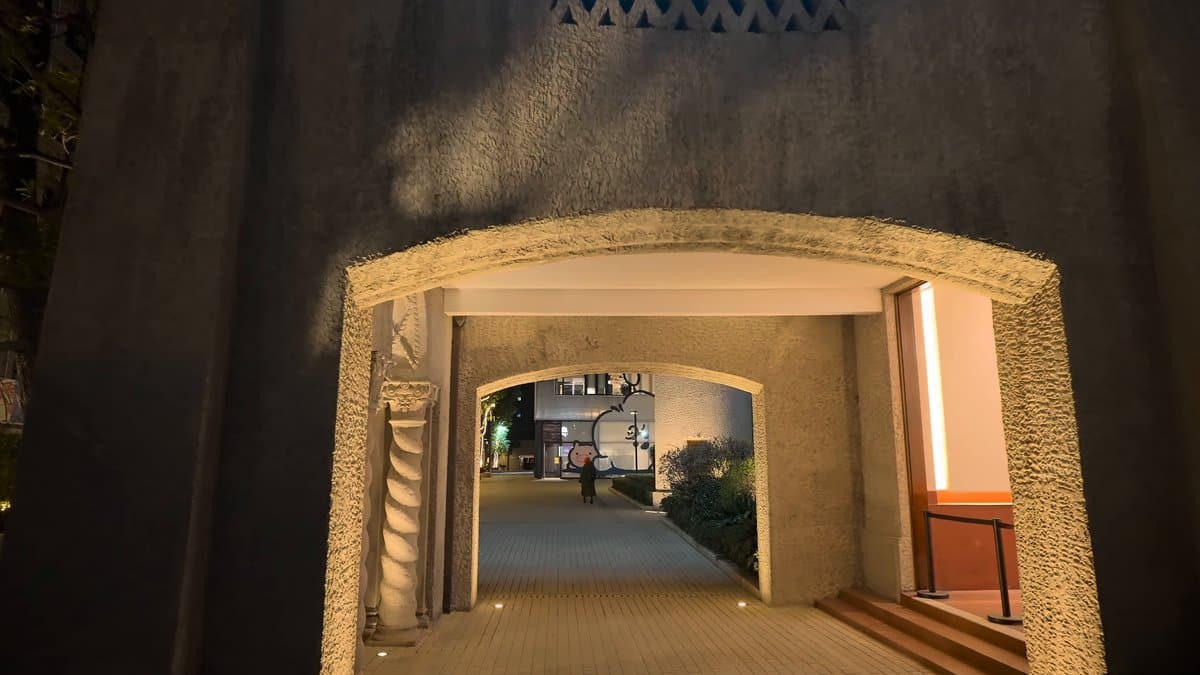 A passage through the building lit from within,