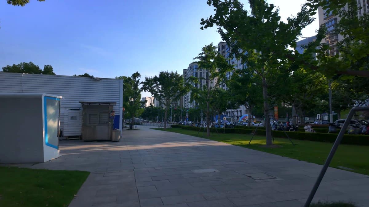 A paved area with a kiosk standing among
