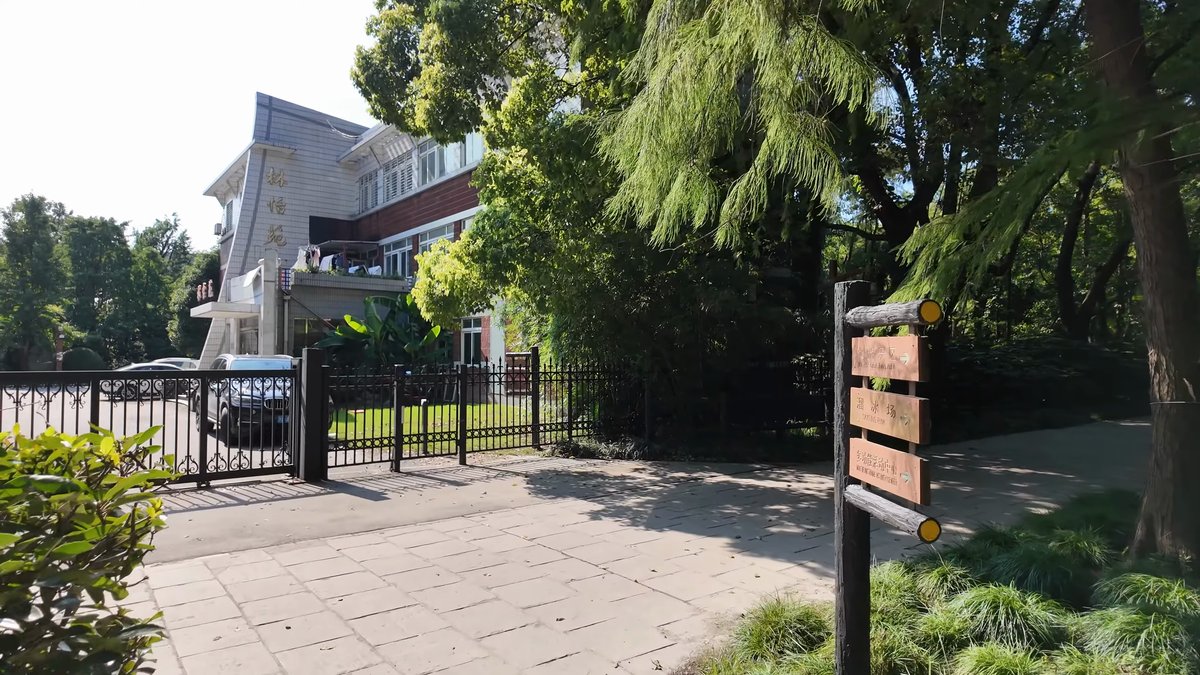 A paved forecourt with an information board and