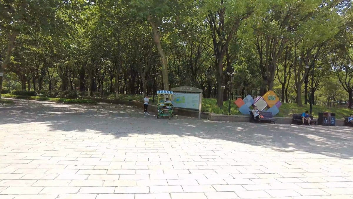 A paved plaza inside the gate with trees,