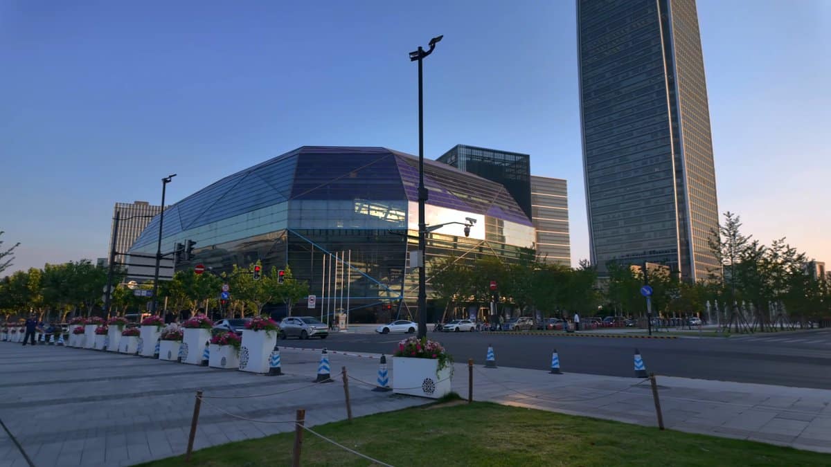 A plaza at dusk with glass office blocks