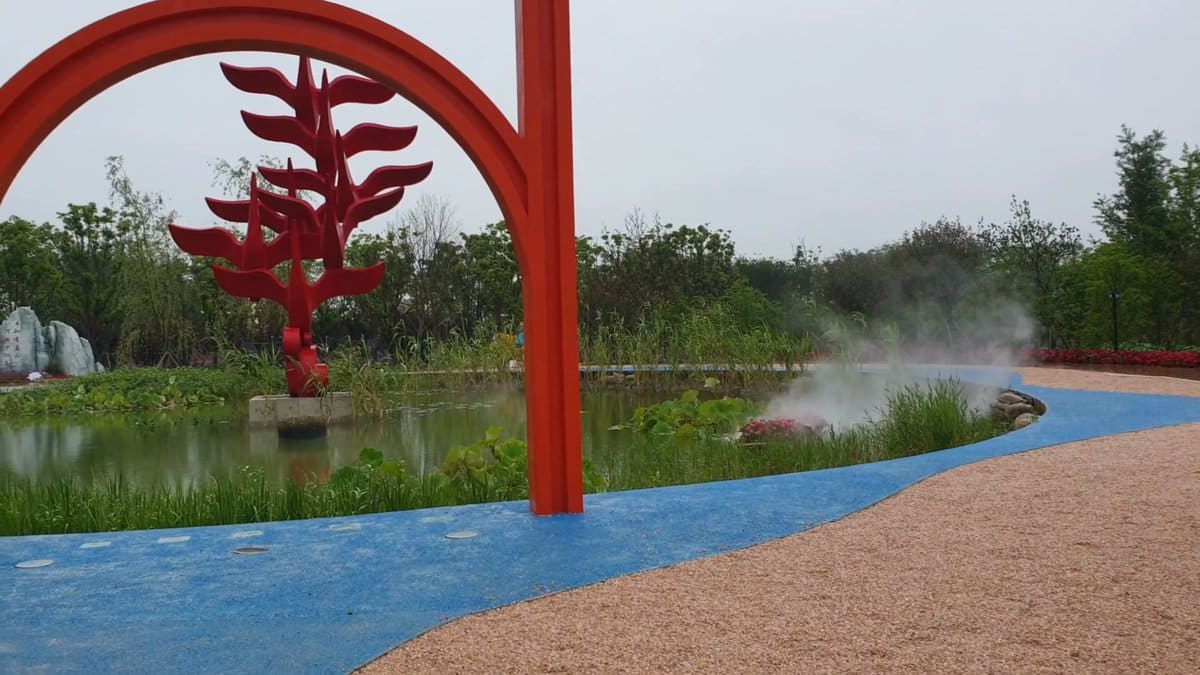 A red steel arch carrying a cut leaf