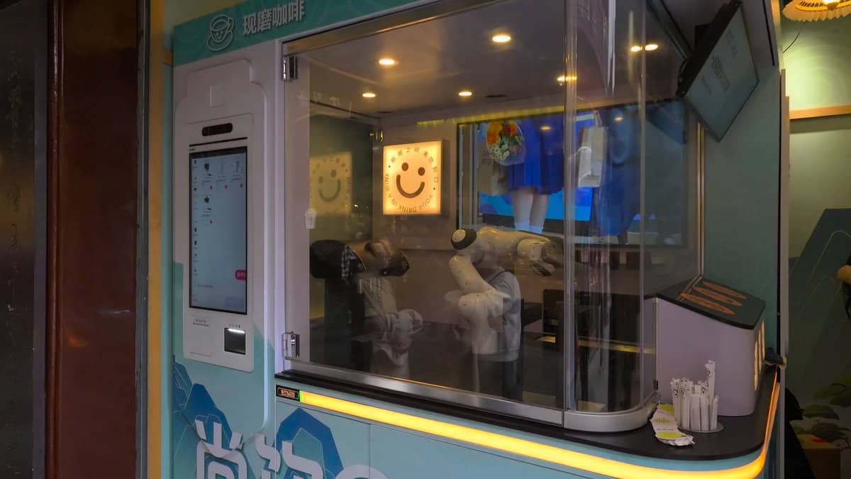 A robotic coffee kiosk — a glazed booth