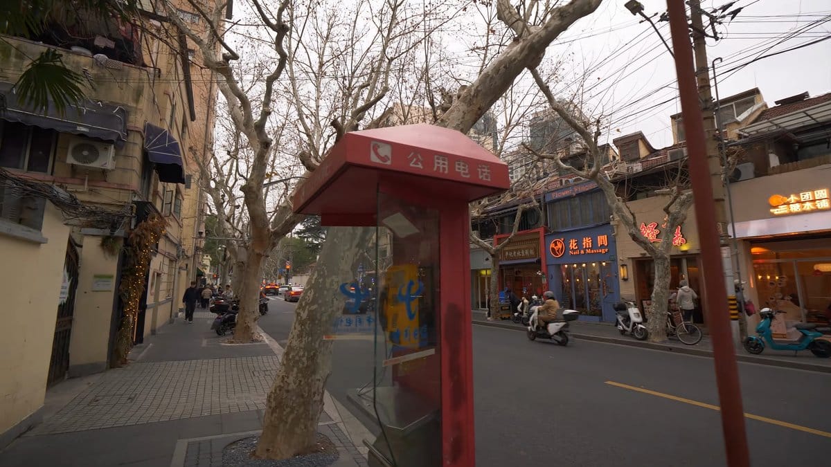 A street with a red kiosk at the