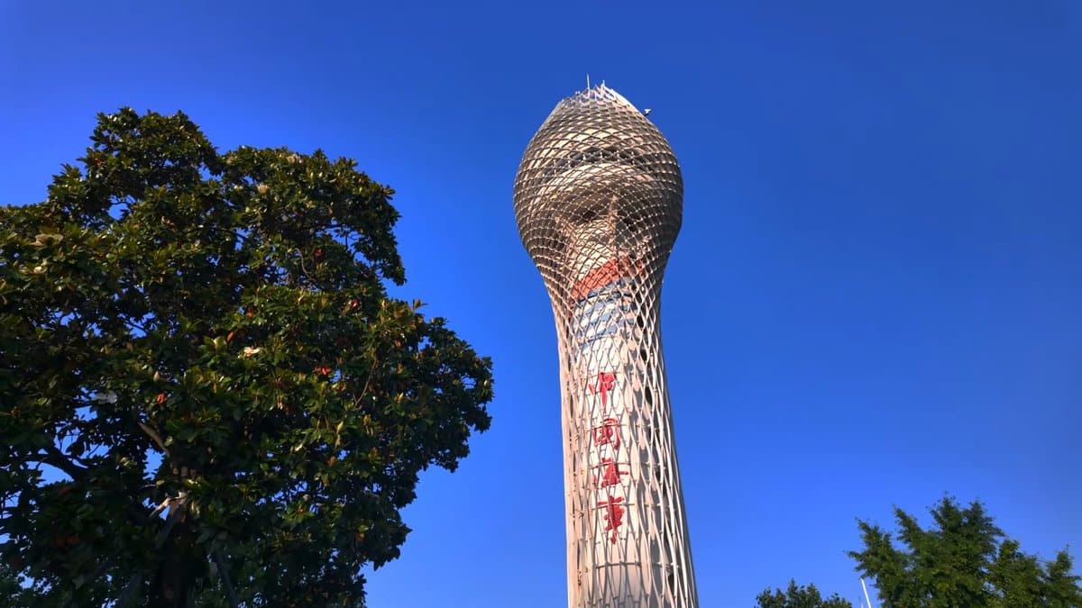 A tall latticework tower glimpsed through the tree