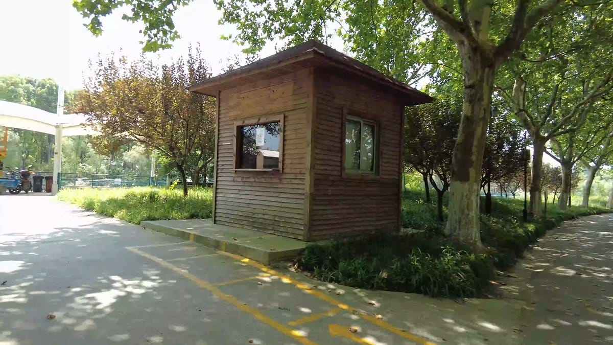 A timber kiosk beside the cycle path, yellow