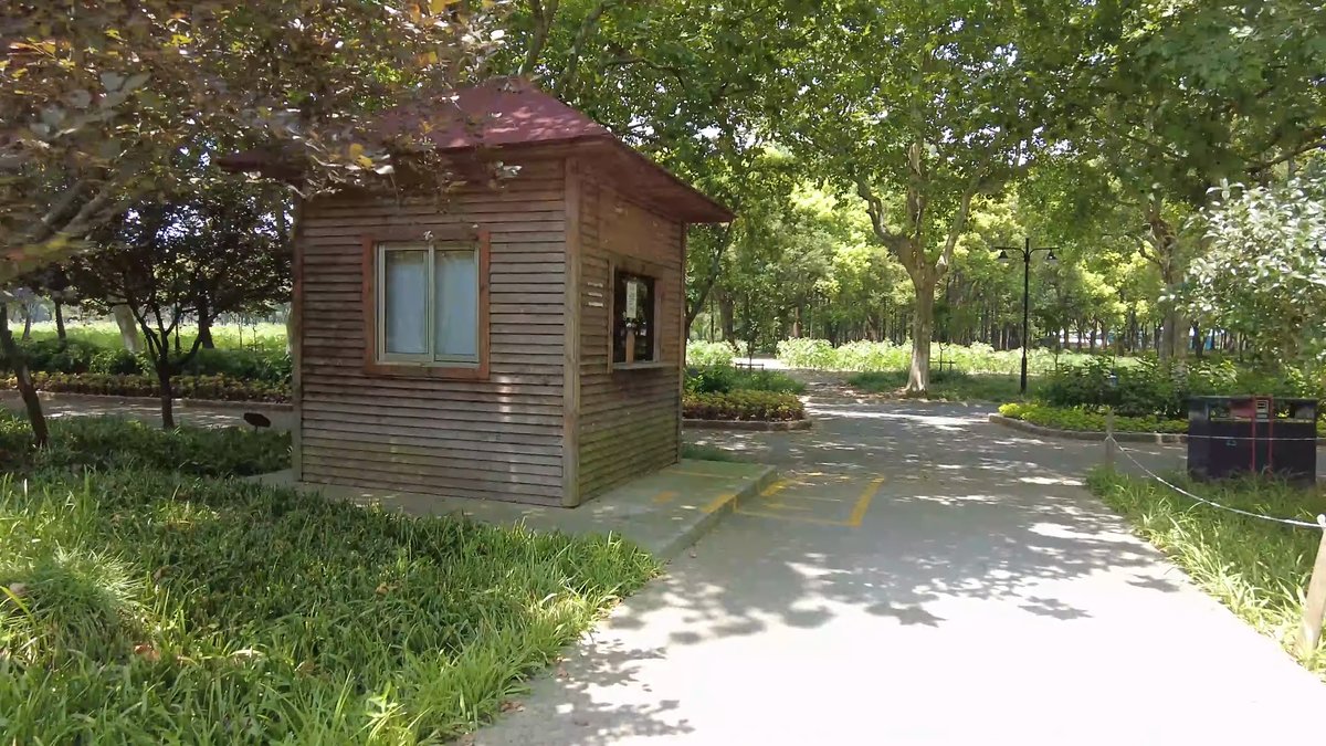 A timber kiosk standing on the path among