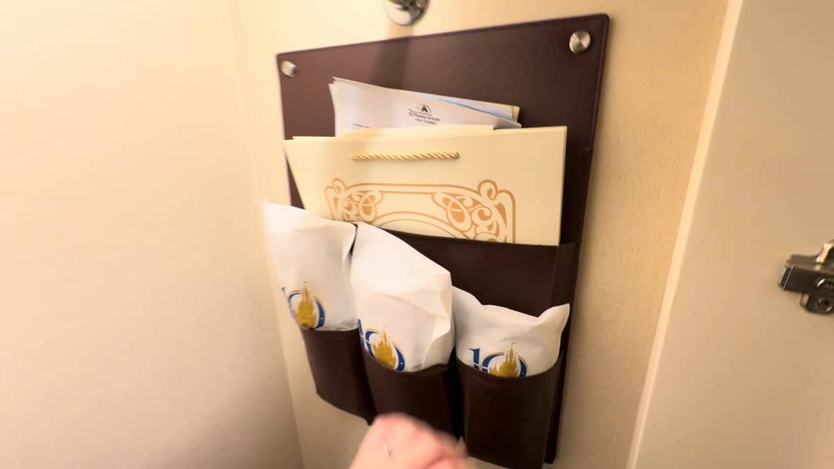 A wall-mounted wooden rack by the door holding