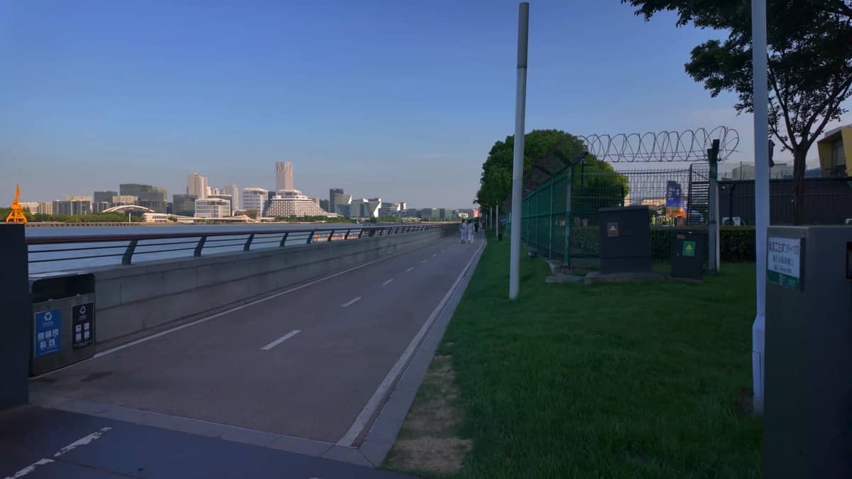 An elevated road deck behind a fence, the