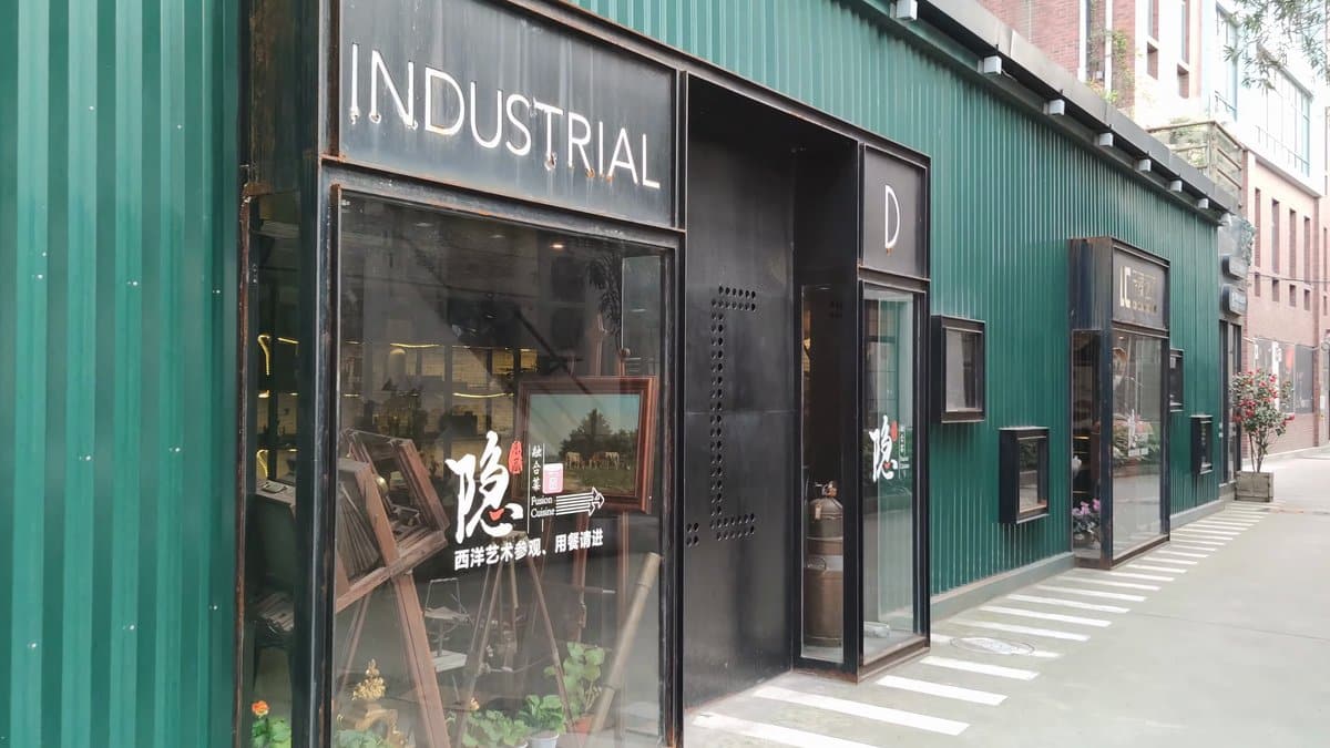 An INDUSTRIAL shopfront set into a green corrugated
