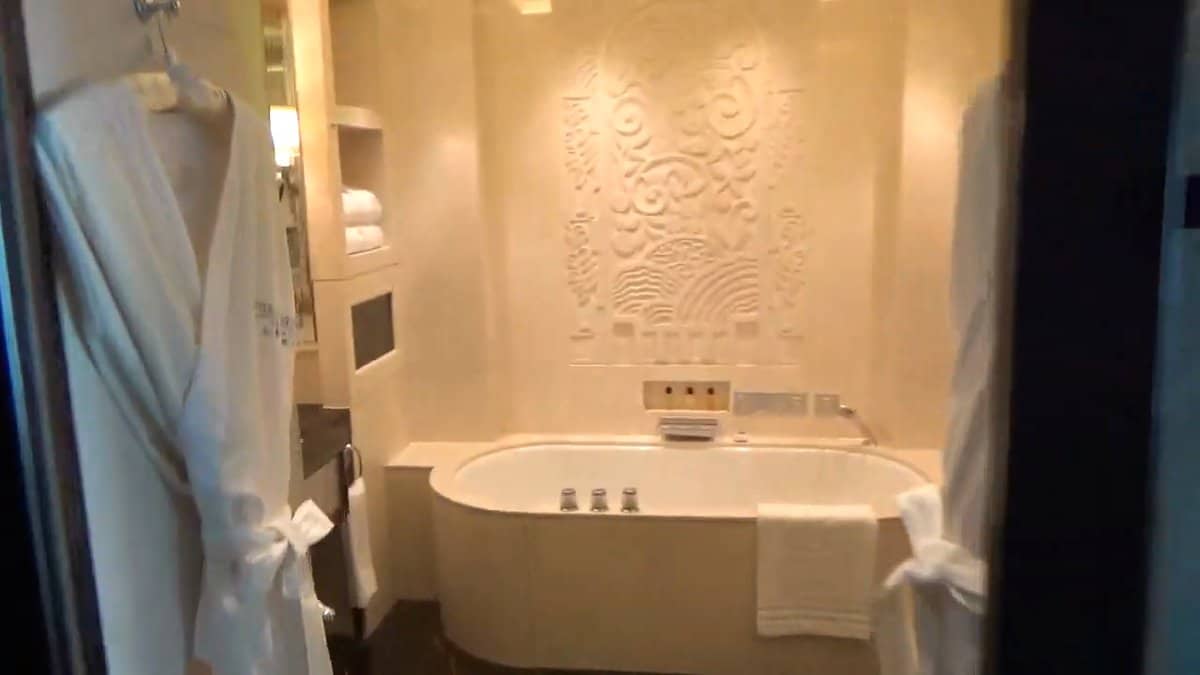 Art-deco bathtub in marble alcove