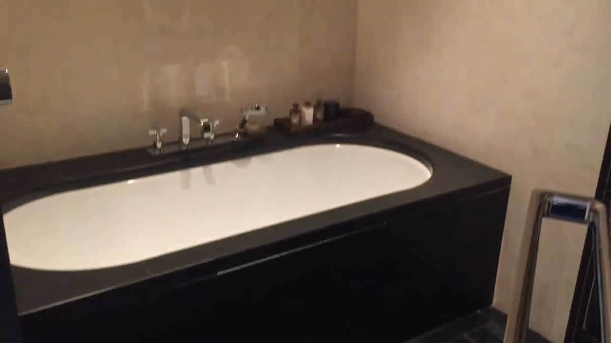 Bathtub set in black stone surround