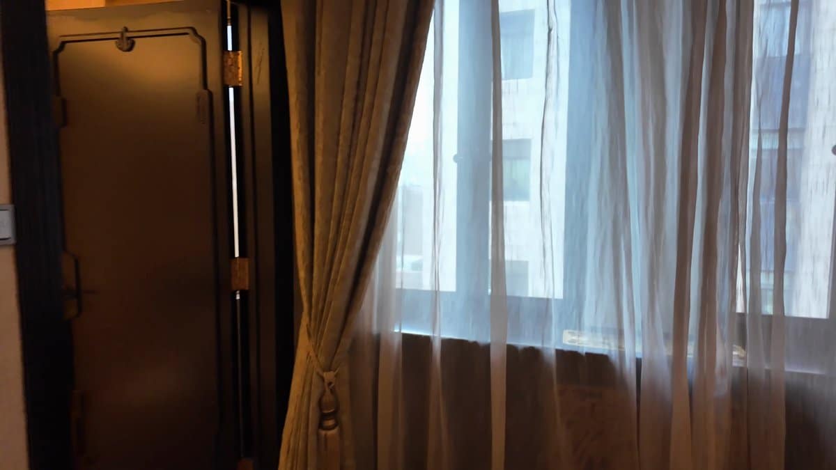 Bedroom window with heavy drapes