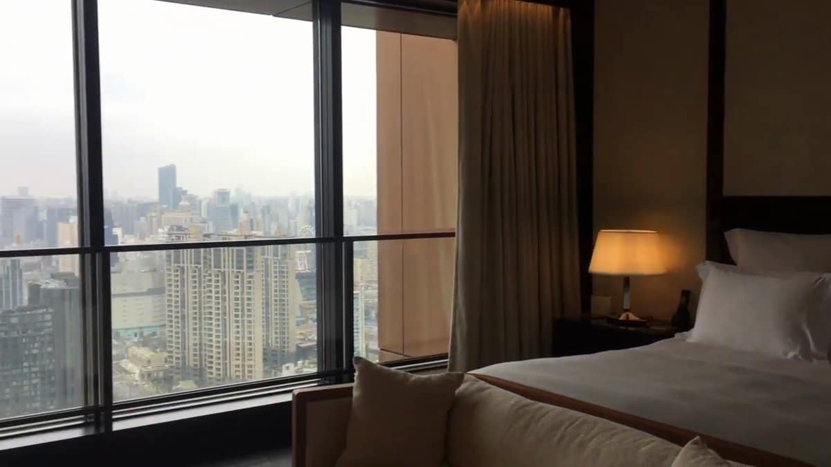 Bedroom with floor-to-ceiling glass walls