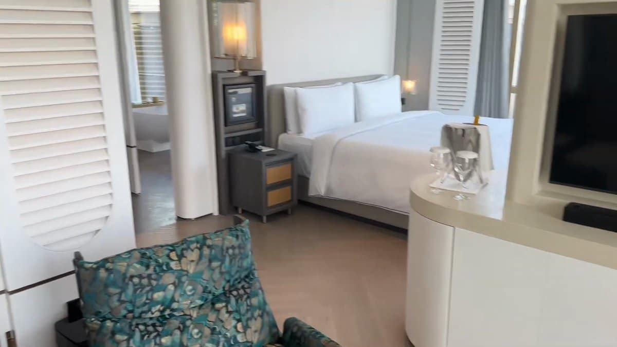 Bedroom with louvred shutters open