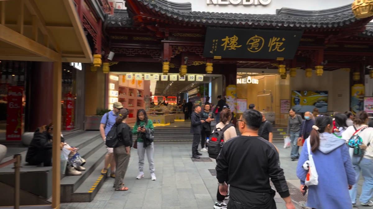 Beneath a hall carrying the board 華寶樓 with