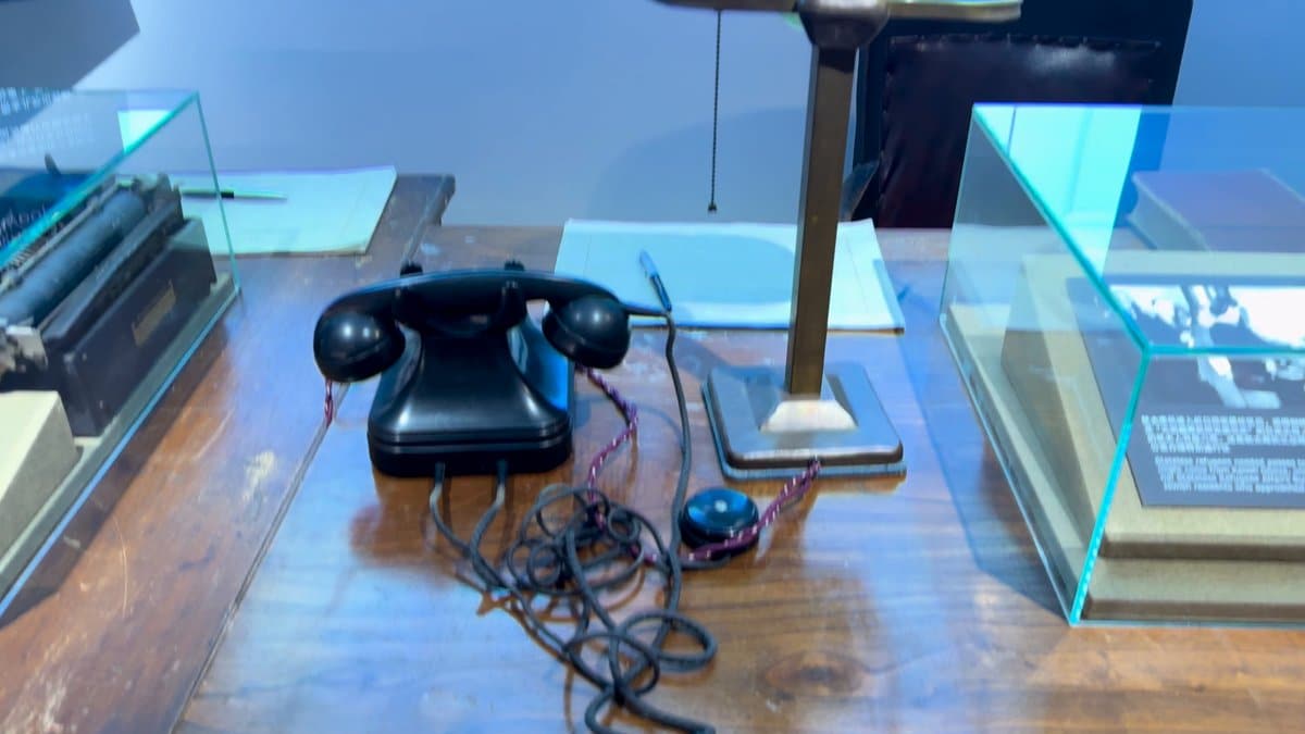 Black rotary telephone on desk