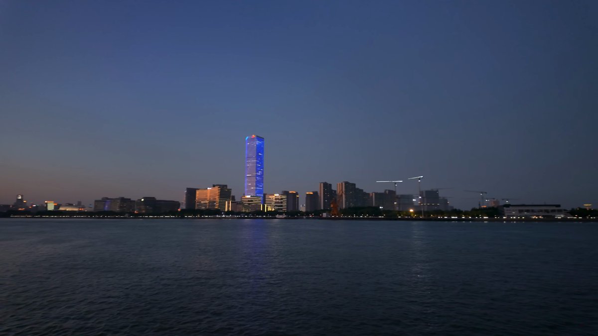 Blue-lit tower on the far bank