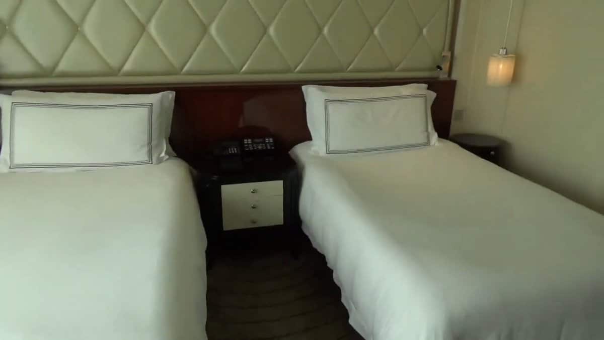 Both beds together, the quilted headboard running the
