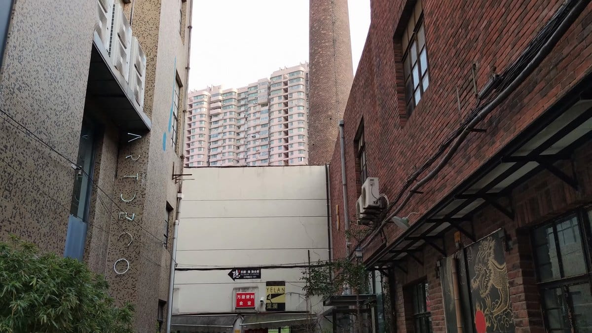 Brick lane with shopfronts and towers