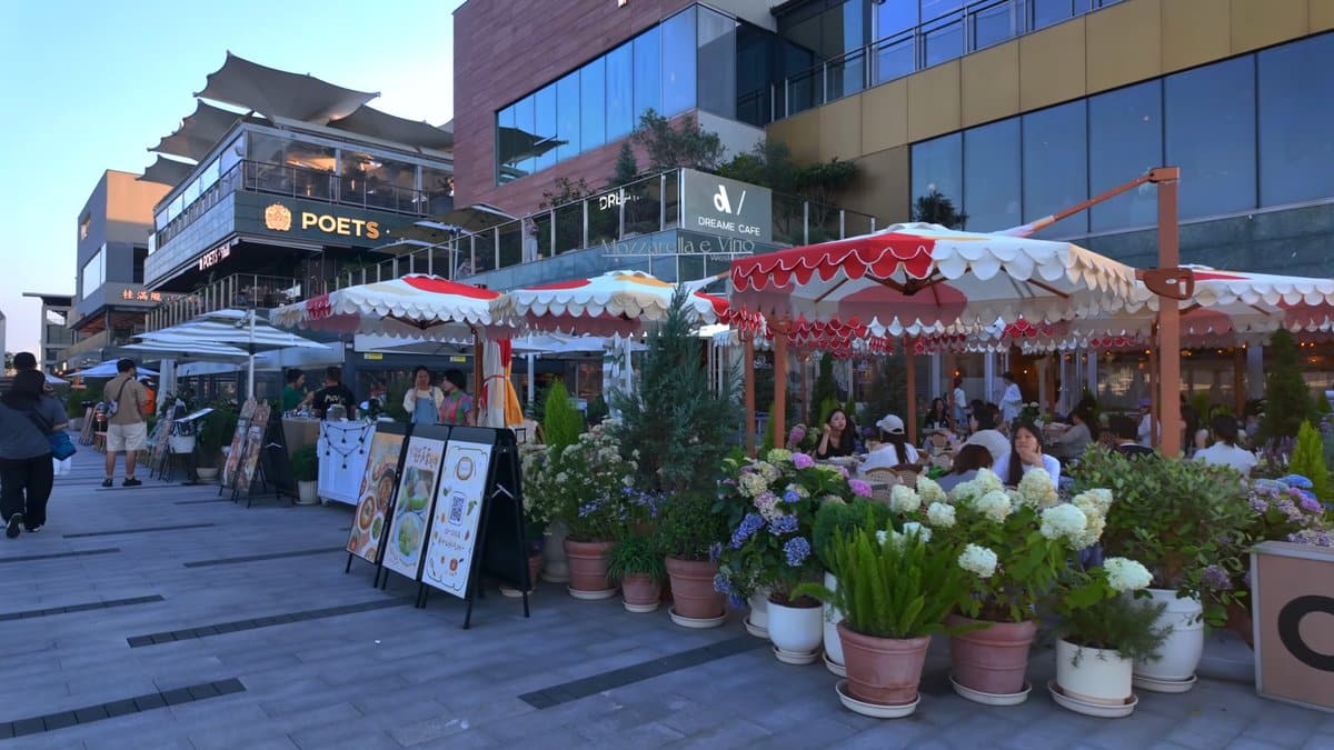 Cafe tables under red-striped parasols