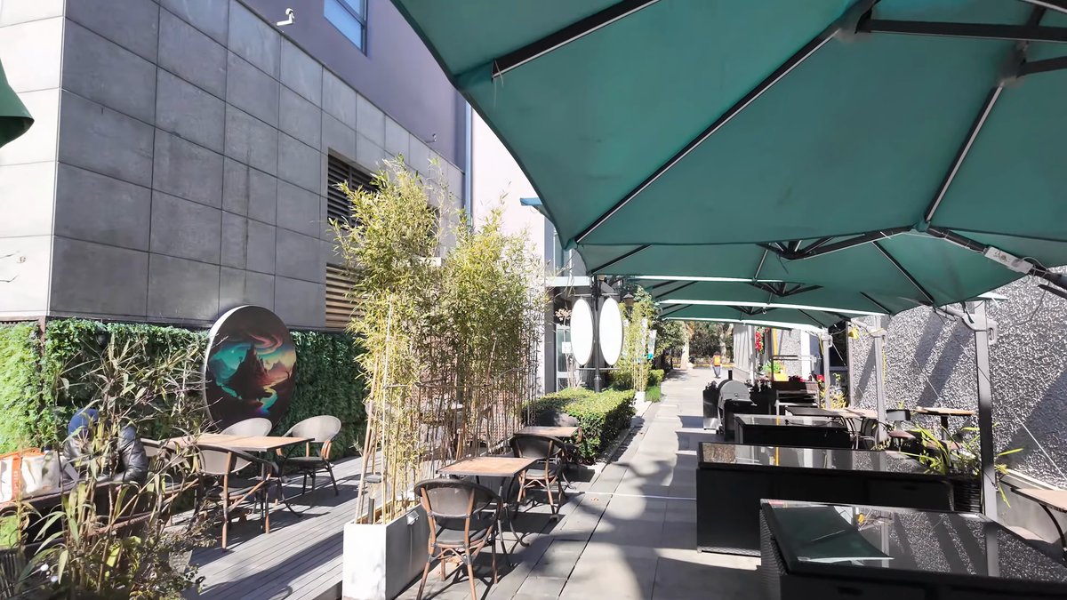 Cafe terrace under green parasols
