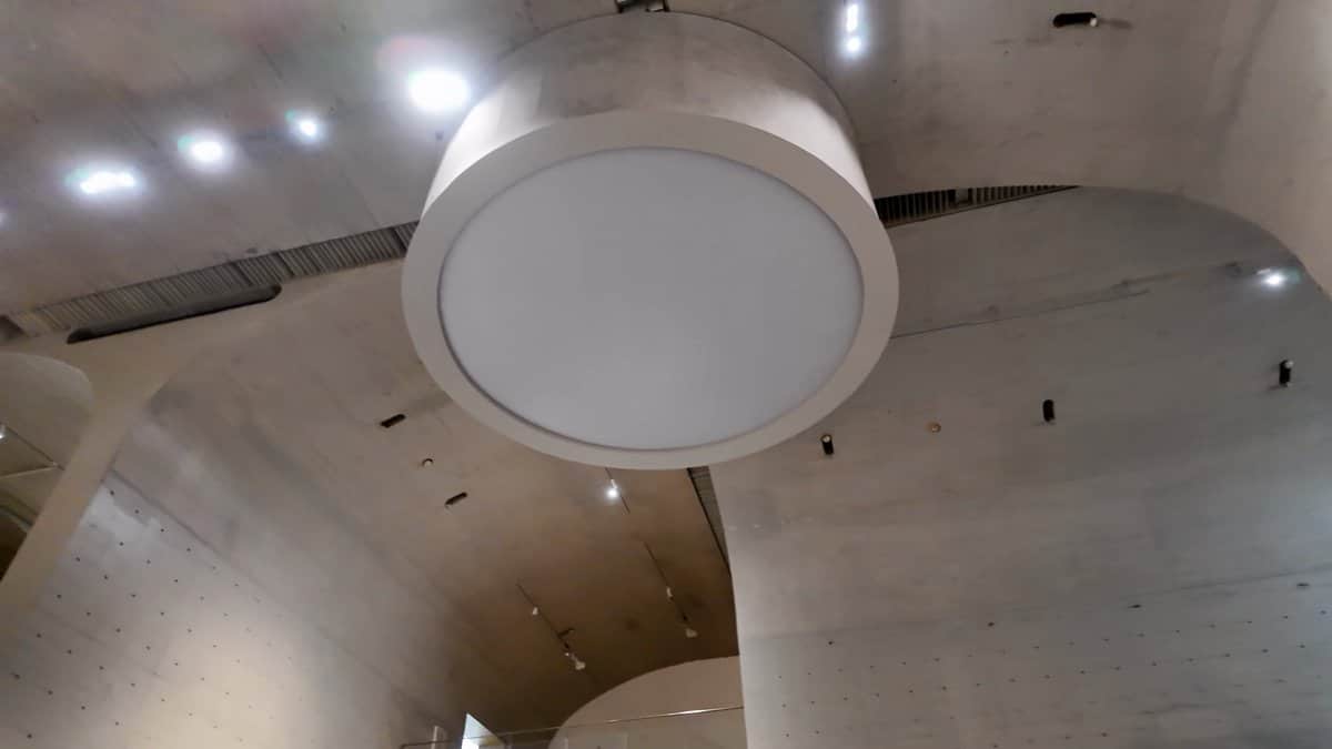 Circular pendant under vaulted ceiling