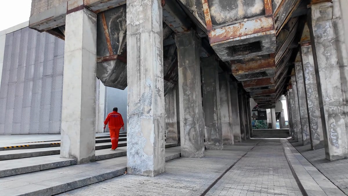Concrete colonnade under the museum