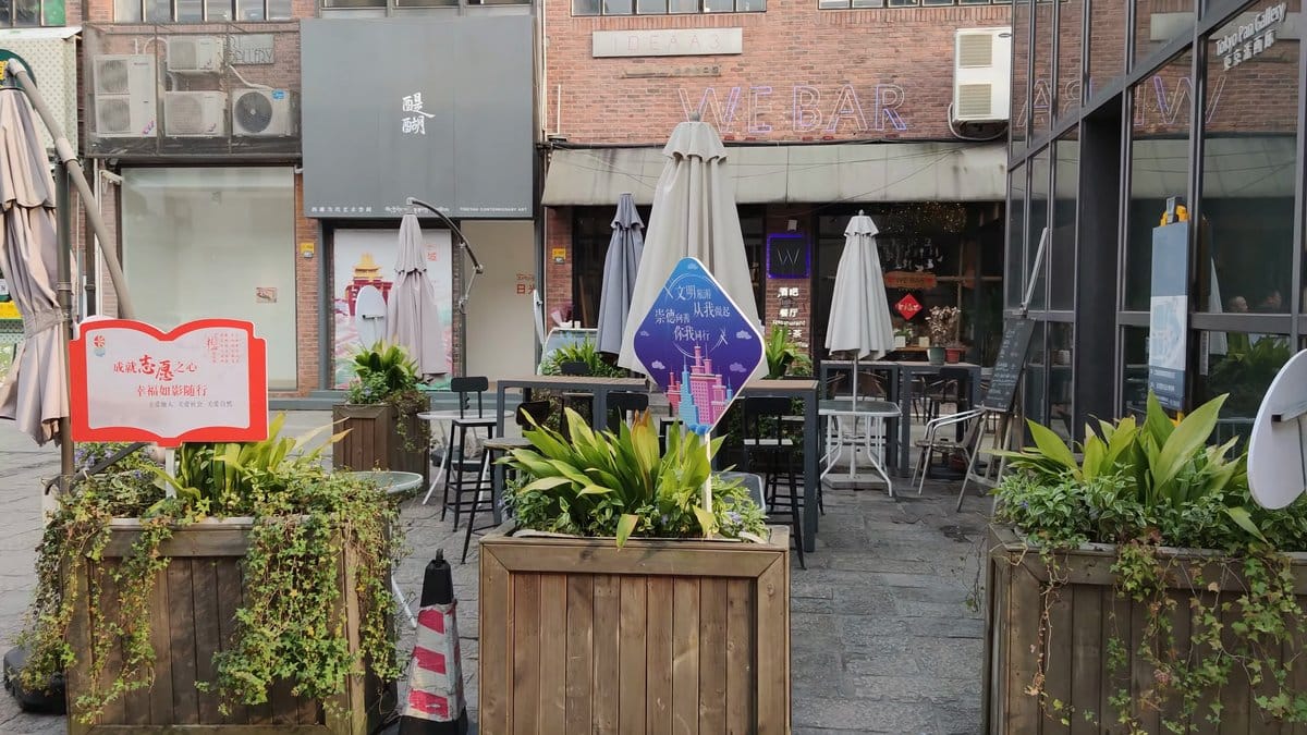Courtyard cafe tables among planters