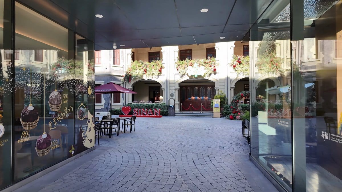 Courtyard glimpse through glazed passage