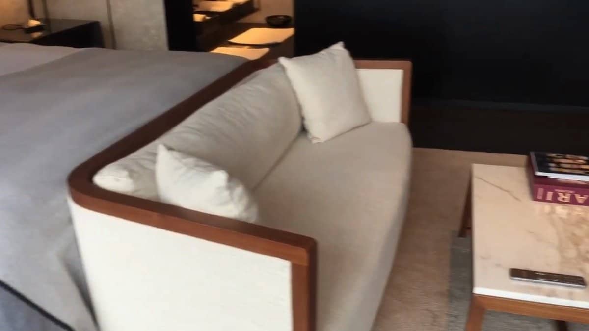 Curved sofa with pale upholstery