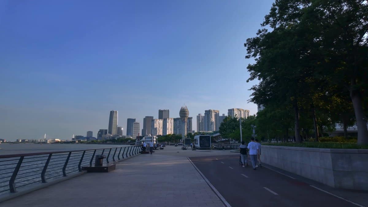 Cyclists along the riverfront skyline
