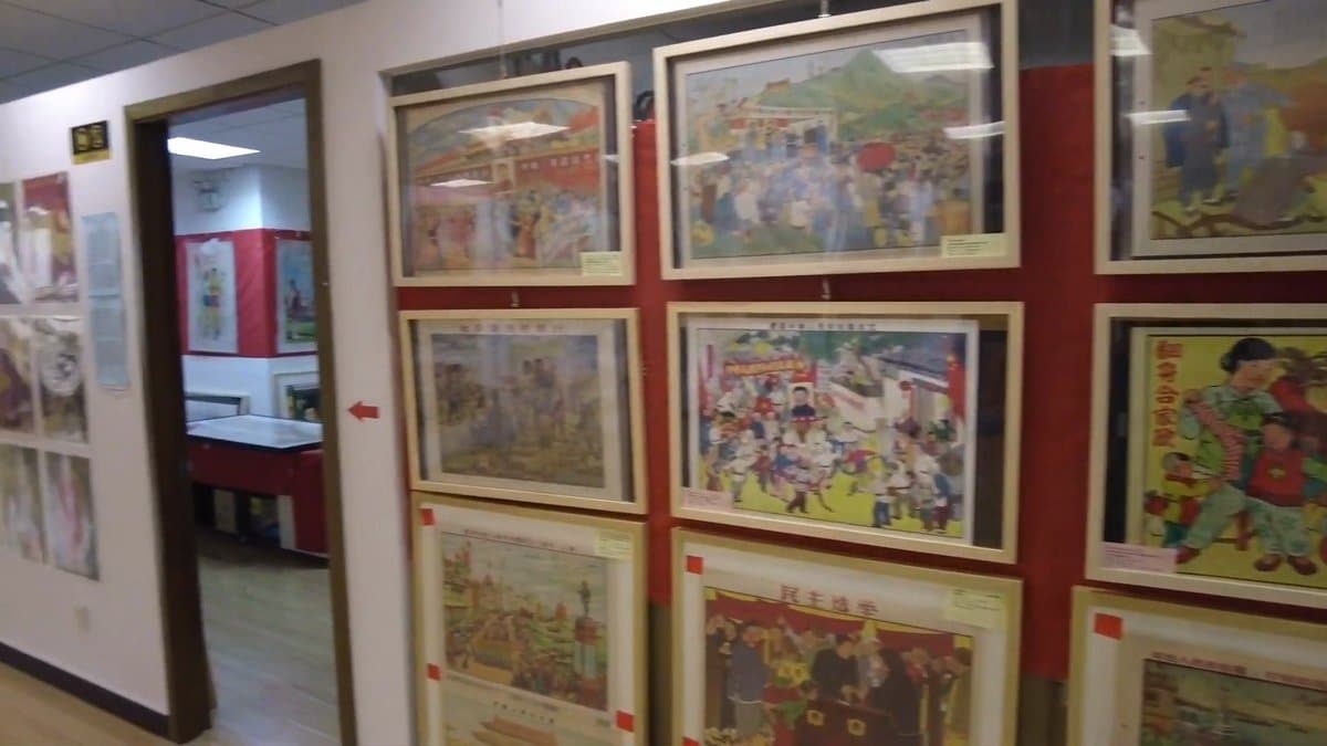 Dense posters on a red wall