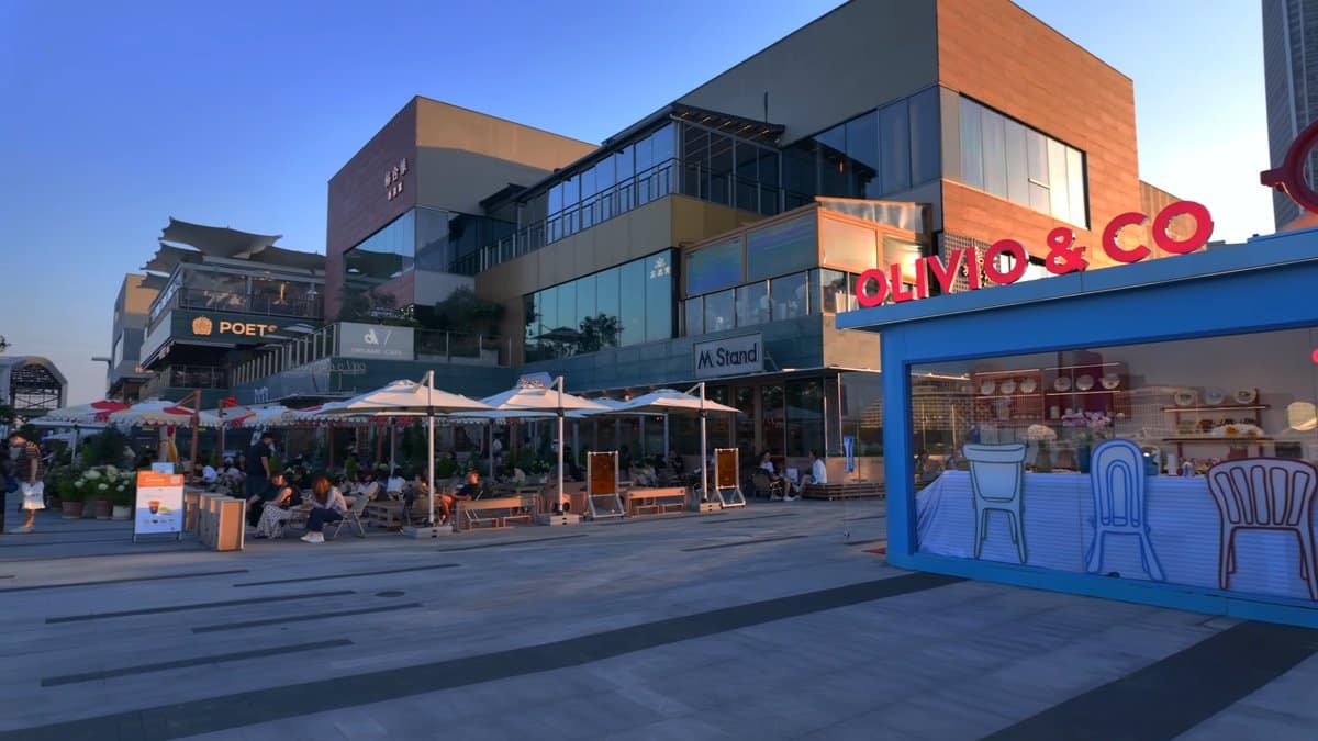 Evening retail terraces under outdoor parasols
