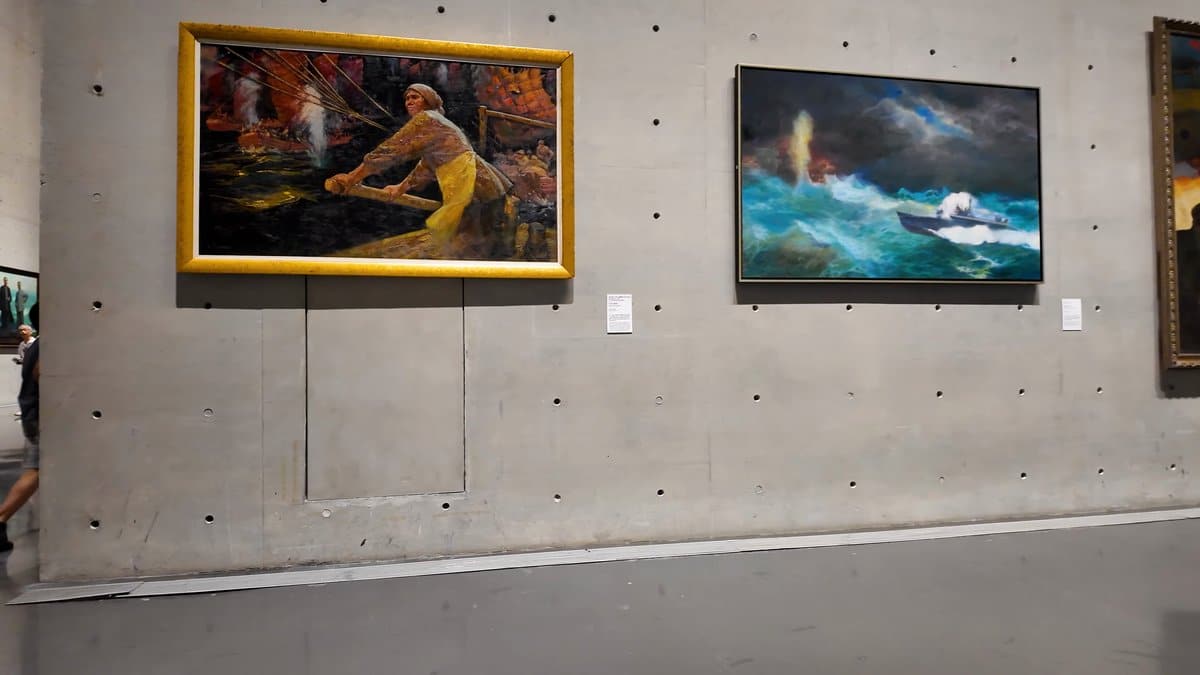 Figure painting beside a seascape