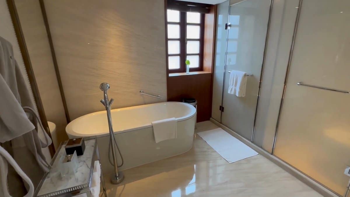 Freestanding tub by shuttered window
